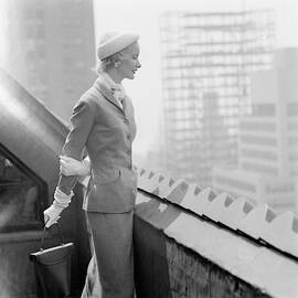 A Model In A Tweed Suit Standing On A New York by Richard Rutledge