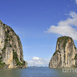 Limestone karst peaks islands in Ha long Bay by Sami Sarkis Photography
