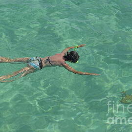 Woman snorkeling by turquoise sea by Sami Sarkis Photography