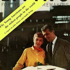 A Couple Looking At A Scale Model Of A House by Burt Owen