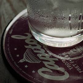 A Glass On A Coaster by Romulo Yanes