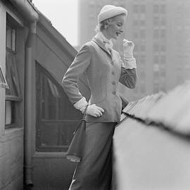 A Model In A Tweed Suit Standing On A New York by Richard Rutledge