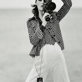 A Model Looking Through A Beaulieu Camera Wearing by Gianni Penati