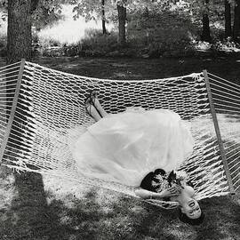 A Model Lying On A Hammock by Gene Moore