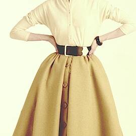 A Model Wearing A Cream Sweater And Camel Skirt by Richard Rutledge