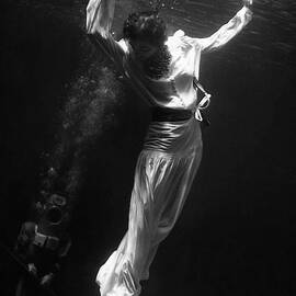 A Model Wearing A Dress Underwater by Toni Frissell