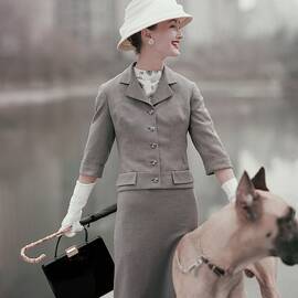 A Model Wearing A Gray Suit With A Dog by Karen Radkai
