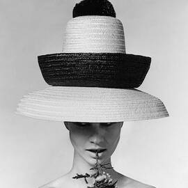 A Model Wearing A Sun Hat by Karen Radkai