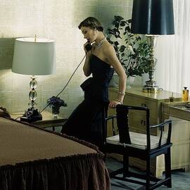 A Model Wearing An Evening Gown On The Telephone by Herbert Matter