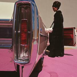 A Model Wearing Emeric Partos Entering A 1965 by Gene Laurents