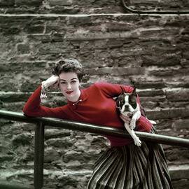 A Model With A Dog Leaning On A Railing by Richard Rutledge