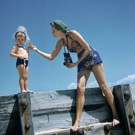 A Mother And Son On A Pier by Toni Frissell