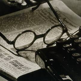 A Pair Of Glasses On Top Of A Newspaper by Irving Browning