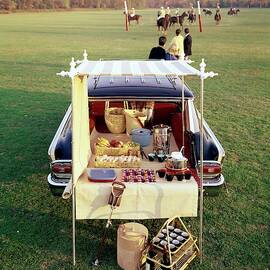A Picnic Table Set Up On The Back Of A Car by Rudy Muller
