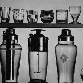 A Row Of Glasses On A Shelf by The 3