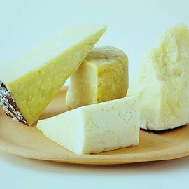 A Variety Of Cheese On A Plate by Romulo Yanes