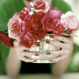 A Woman Holding A Bowl Of Roses by John Rawlings