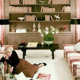 A Woman Reading Magazines On The Floor by Haanel Cassidy