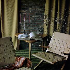 An Armchair Beside A Table And An Old Book by Horst P. Horst