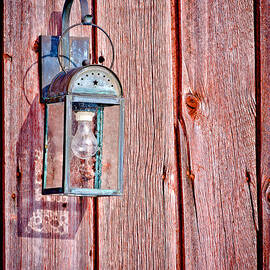 Antique Lantern On Weathered Red Barn by Jeff Sinon