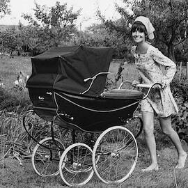 Audrey Hepburn Pushing A Pram by Henry Clarke