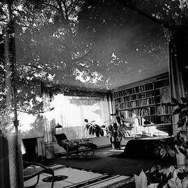 Bedroom Seen Through Glass From The Outside by Robert M. Damora