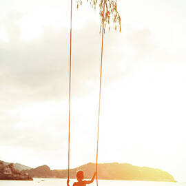 Boy On A Rope Swing by Arand