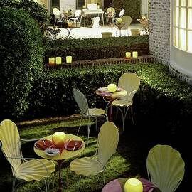 Chairs And Tables In A Garden by Ernst Beadle