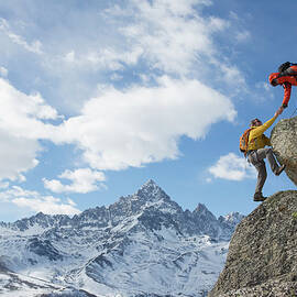 Climber Extends Helping Hand To Teammate by Ascent Xmedia