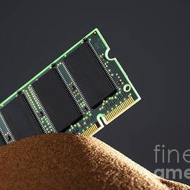 Computer memory chip on red sand by Sami Sarkis Photography
