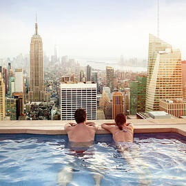 Couple Relaxing On Hotel Rooftop by Orbon Alija