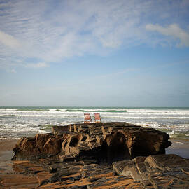 Deck Chairs On Coastal Rock Looking Out by Dougal Waters