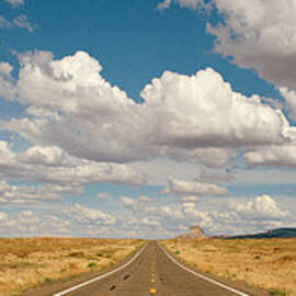 Desert Road With Cloud Formations Above by Gary Yeowell