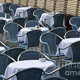 Empty restaurant seats and tables by Sami Sarkis Photography