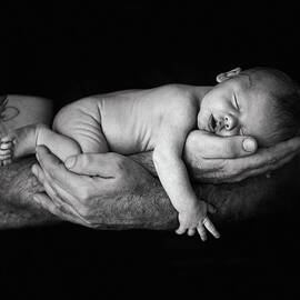 Father Holding Newborn Baby by Lise Gagne