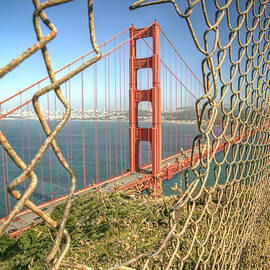 Golden Gate through the fence by Scott Norris