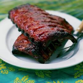 Grilled Ribs On A White Plate by Romulo Yanes