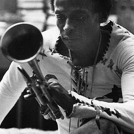 Jazz Musician Miles Davis Looking At His Trumpet by Mark Patiky