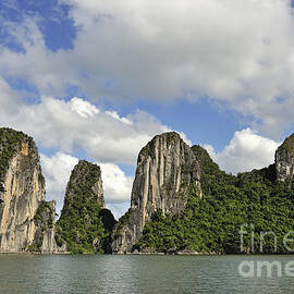 Limestone karst peaks islands in Ha long Bay by Sami Sarkis Photography