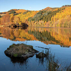 Loch With Reflections Of Autumn Trees by Simon Butterworth