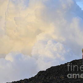 Man contemplating clouds of steam on volcano by Sami Sarkis Photography