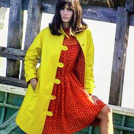 Model On A Boat In A Yellow Over Coat And A Red by Sante Forlano