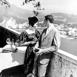 Models Holding Wine On A Balcony by Richard Waite