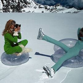 Models On Plastic Chairs With Snow In Switzerland by Arnaud de Rosnay