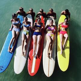 Models Wearing Bikinis Lying On Surfboards by William Connors