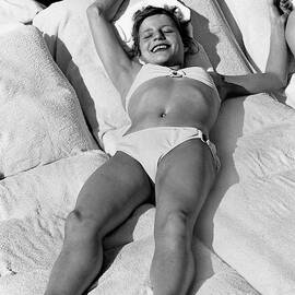 Olga Korbut Lying Down In The Sun by Duane Michals