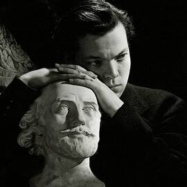 Orson Welles Resting On A Sculpture by Cecil Beaton