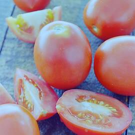 Plum Tomatoes On A Wooden Board by Romulo Yanes