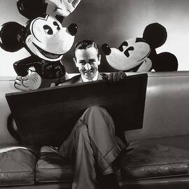 Portrait Of Walt Disney Sitting With Open Cartoon by Edward Steichen
