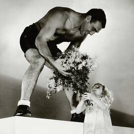 Primo Carnera Receiving Flowers From A Little by Edward Steichen